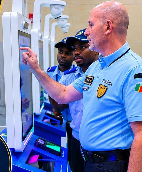 Police officer operating a Brithol Michcoma e-Gate identity kiosk